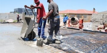 Construction workers pour cement on site, reflecting the labour-intensive building industry where leaders and SMEs are calling for practical regulation that balances compliance requirements with worker protection.
Photo: SANS