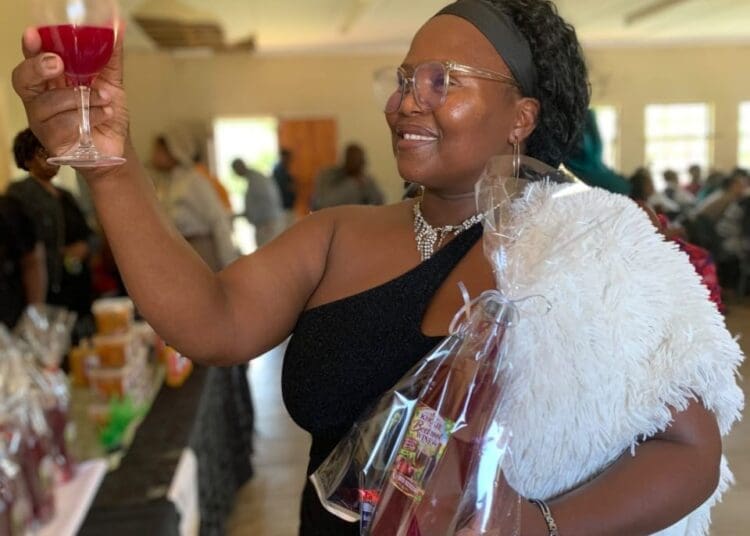 Abongile Kholeka Mdubeki (39), founder of Kholie Care from Mzingazi Agri-Village, showcases her handmade Kholie Beetroot Wine.